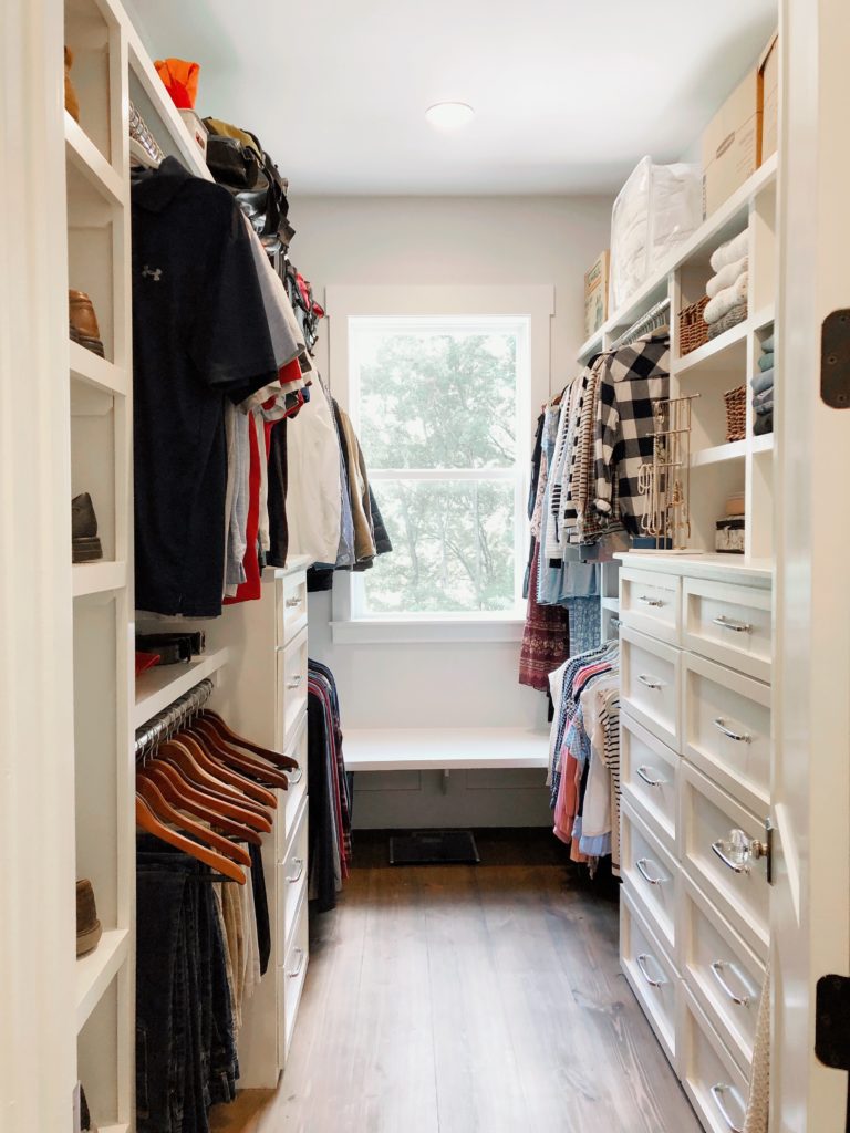 a walk-in master closet organized by Nolensville Home Organizing