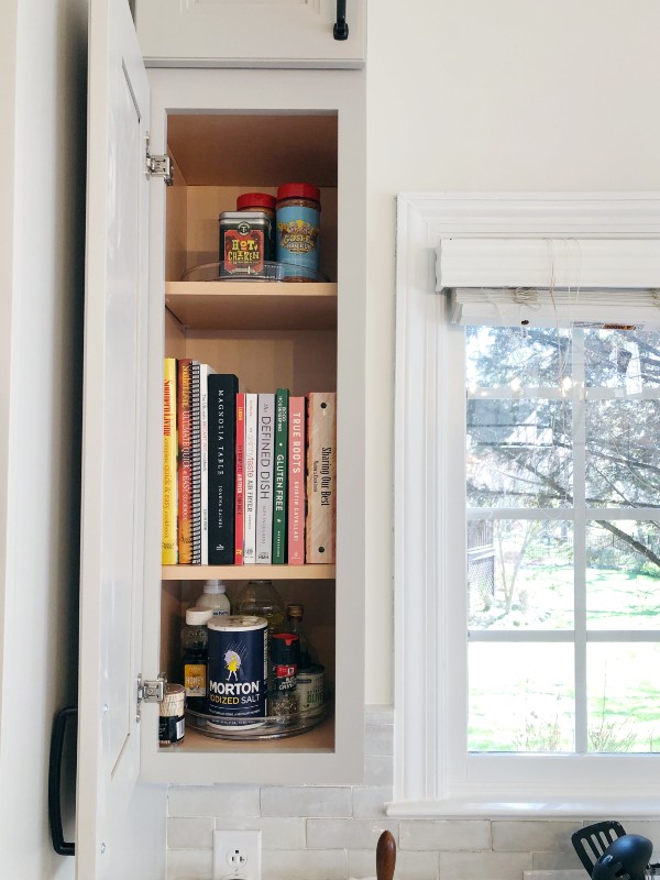 Small kitchen cabinet with cookbooks and seasoning organized by Nolensville Home Organizing