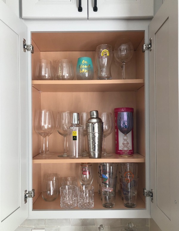 Kitchen cabinet with glasses organized by Nolensville Home Organizing