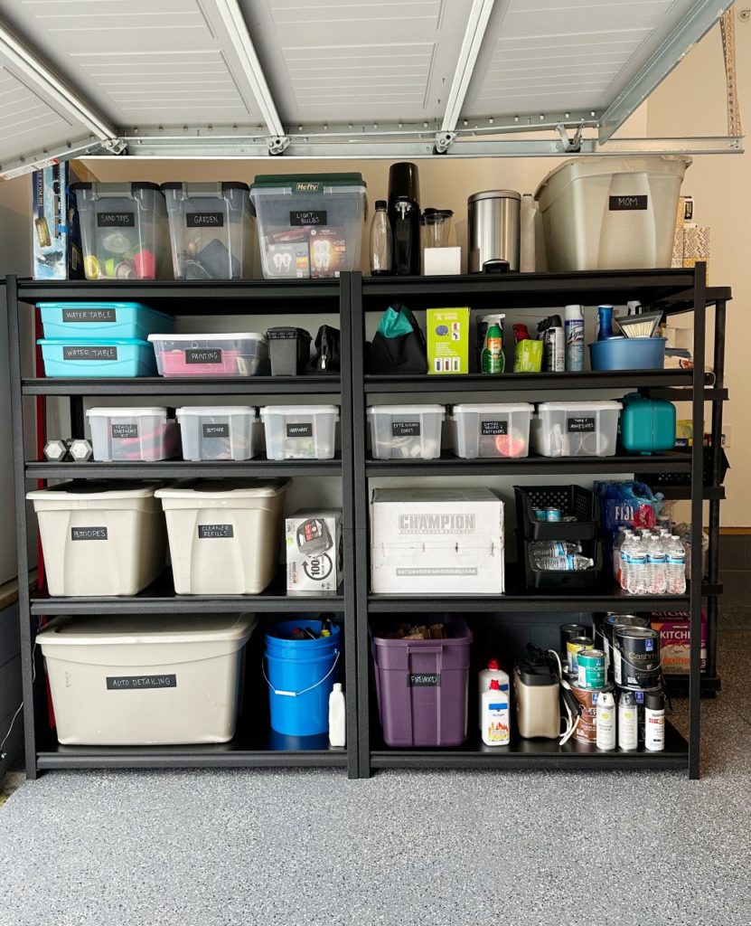 interior of a garage with black shelving and labeled and organized bins